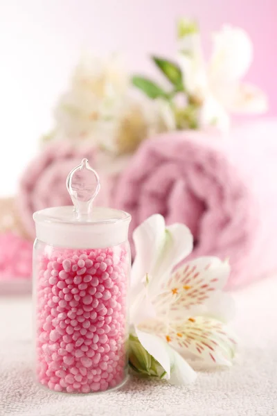 Spa treatment and flowers on wooden table, on light background — Stock Photo, Image