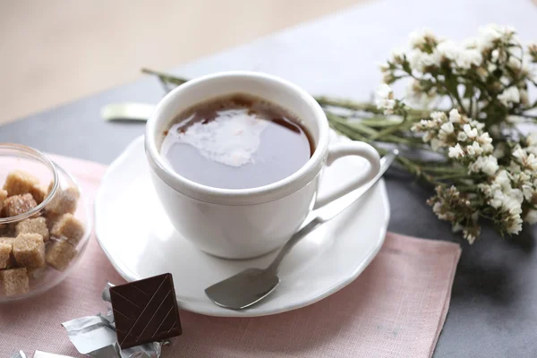 Cup of flavored coffee with chocolate on table with napkin, closeup — Stock Photo, Image