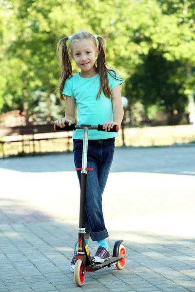 Girl riding on scooter — Stock Photo, Image