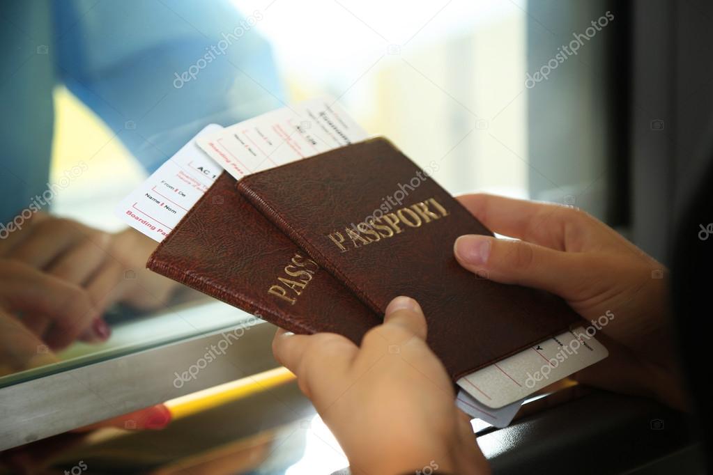 Woman buying tickets with passports