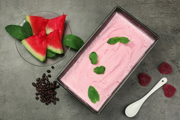 Homemade ice cream in frozen metallic container on k wooden background