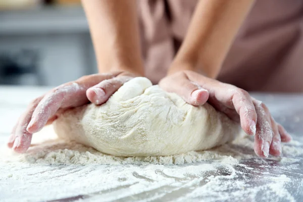 Making dough by female hands