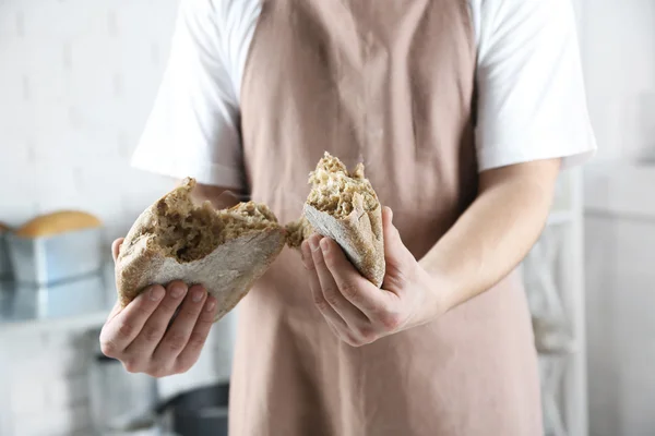 Baker checking freshly baked bread — Stock Photo, Image