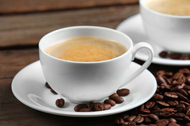 Bardak kahve ve ahşap masa fasulyeli yakın çekim