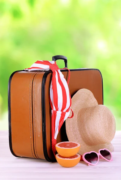 Suitcase and accessories for travelling on bright background — Stock Photo, Image