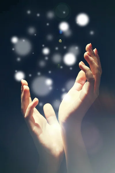 Light in human hands in the dark — Stock Photo, Image