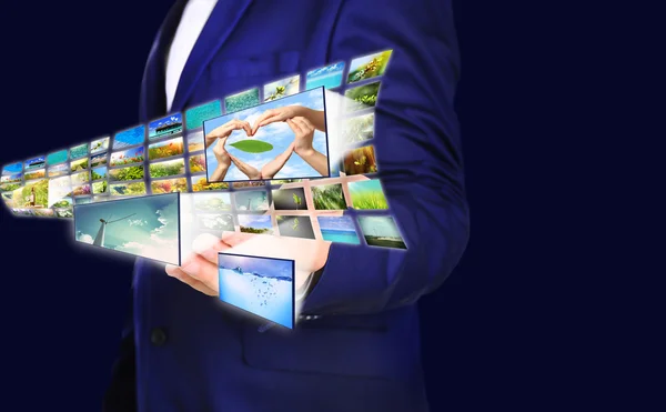 Businessman holding airplane of images — Stock Photo, Image