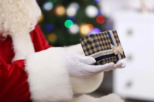 Santa holding gift — Stock Photo, Image