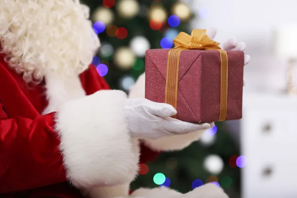 Santa holding gift — Stock Photo, Image