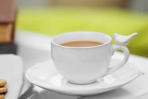 Cup of coffee on table in living room — Stock Photo, Image