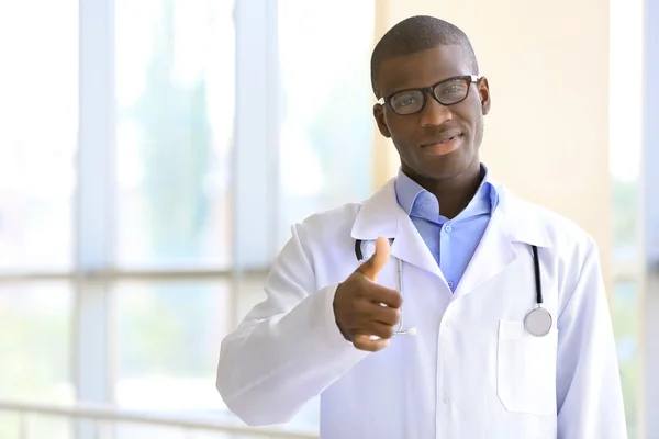 Handsome African American doctor with stethoscope in hospital — Stock Photo, Image