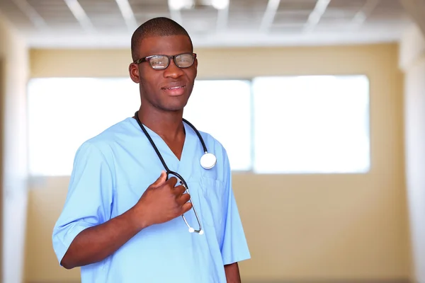 Handsome African American doctor with stethoscope in hospital — Stock Photo, Image