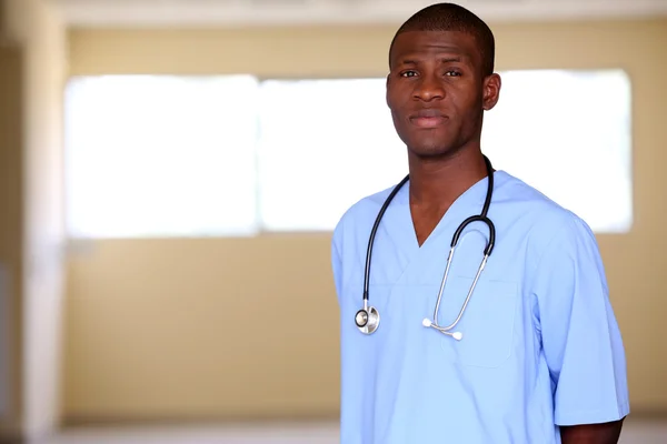 Handsome African American doctor with stethoscope in hospital — Stock Photo, Image