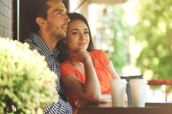 Young couple drink coffee in cafe outdoors — Stock Photo, Image