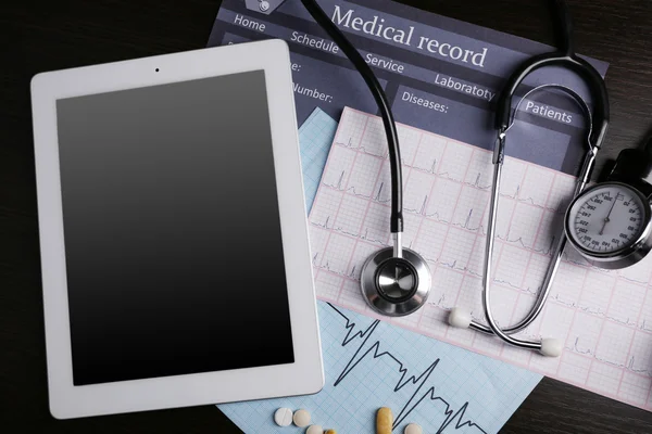 Vérnyomás mérő, sztetoszkóp, digitális tabletta, a sötét háttér — Stock Fotó