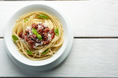 Spagetti Bolognese renk ahşap arka plan üzerinde beyaz kase parmesan peyniri ile