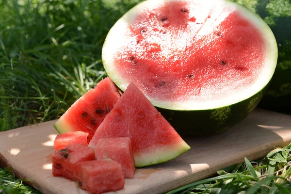 Fresh watermelon over green grass background — Stock Photo, Image