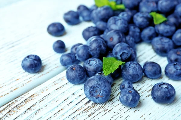 Fresh blueberries with mint on wooden table close up — Stock Photo, Image