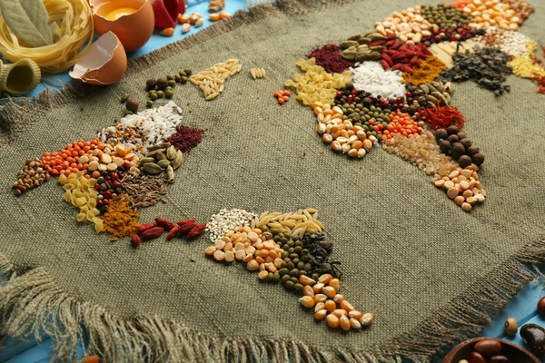 Spices on sackcloth on wooden background — Stock Photo, Image