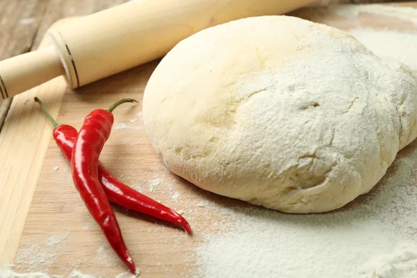 Dough on cutting board with chili close up — Stock Photo, Image