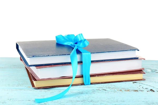 Montón de libros con cinta sobre mesa aislada sobre blanco — Foto de Stock