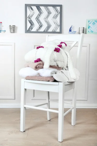 Bath set with white bathrobe on chair, indoors — Stock Photo, Image