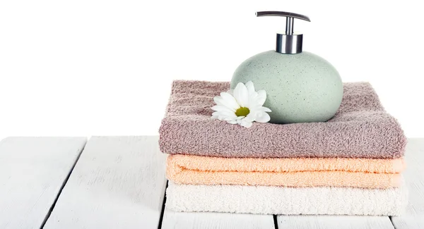 Soft towels with dispenser and flower isolated on white — Stock Photo, Image