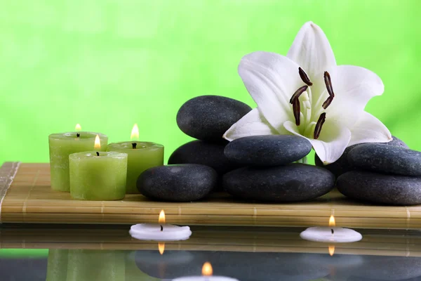 Still life with spa stones on green background — Stock Photo, Image