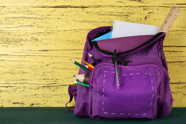 School backpack on wooden background — Stock Photo, Image