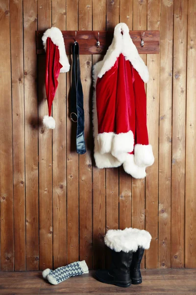 Santa costume hanging on wooden wall background — Stock Photo, Image