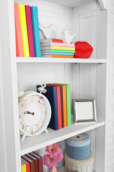 Books and decor on shelves in cupboard