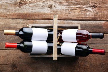 Sepeti ahşap arka plan üzerinde şarap şişeleri