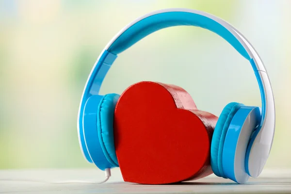 Blue headphones with heart on unfocused background — Stock Photo, Image