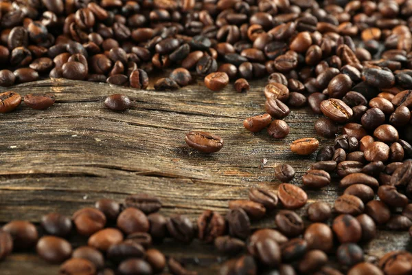 Roasted coffee beans on wooden background — Stock Photo, Image