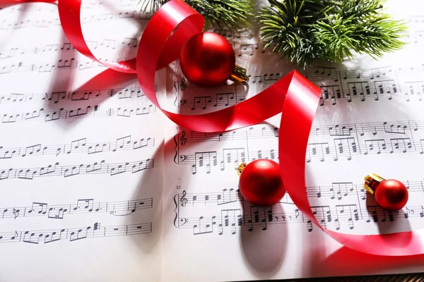 Christmas decor on music notes background — Stock Photo, Image