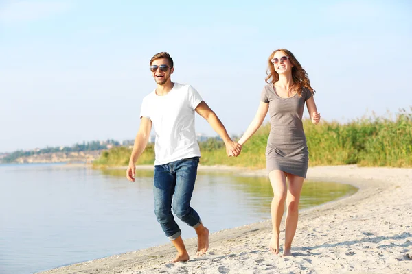 Young couple on the riverside — Stock Photo, Image