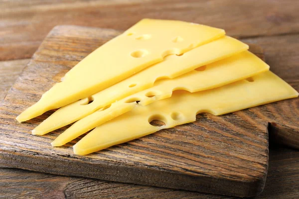 Sliced of cheese on wooden background — Stock Photo, Image
