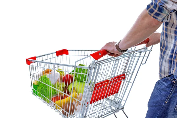 Young man with shopping cart isolated on white — Stock Photo, Image