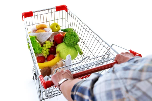 Jovem com carrinho de compras isolado em branco — Fotografia de Stock