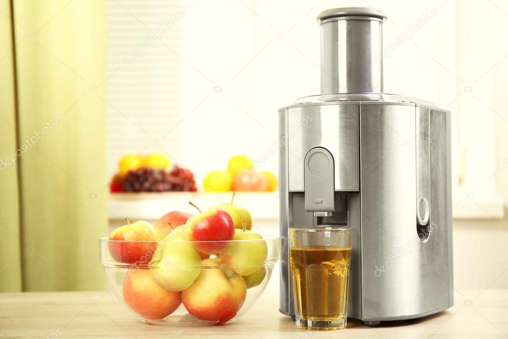 Juicer and apple juice Stock Photo by ©belchonock 86190374