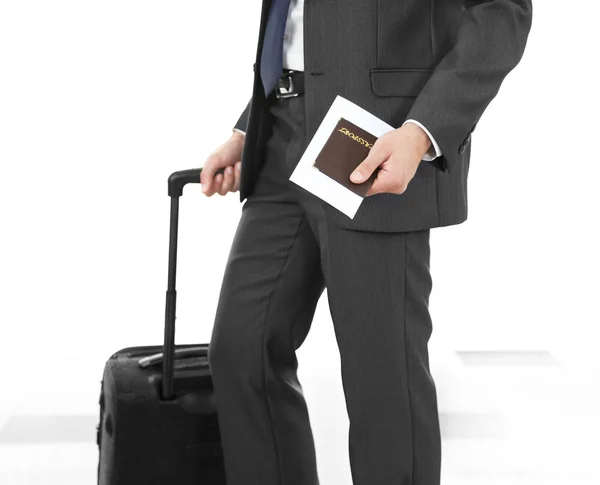 Man holding suitcase on light background — Stock Photo, Image