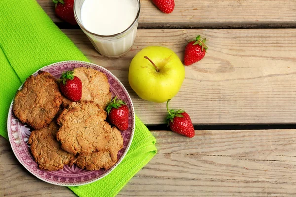 Homemade cookies with fruits and glass of milk on table close up — Stock Photo, Image