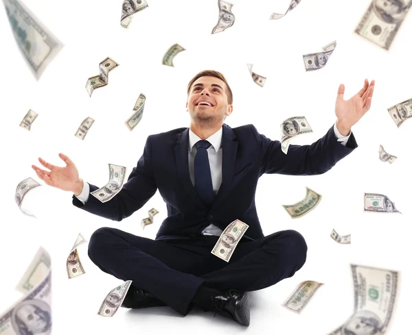 Businessman sitting in the rain of money — Stock Photo, Image