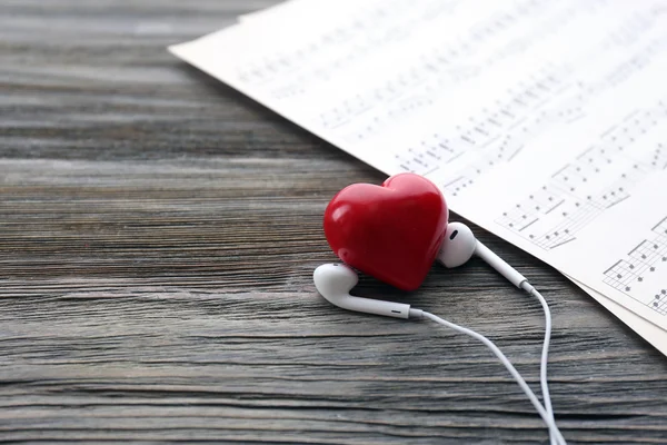 Earphones with red heart — Stock Photo, Image