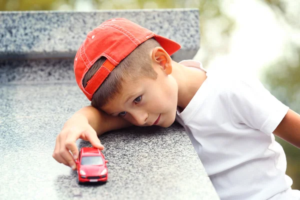 Boy playing with toy car — Stock Photo, Image