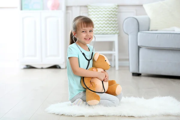 Girl with stethoscope and bear — Stock Photo, Image