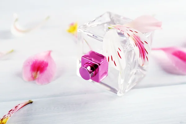 Garrafa de perfume e pétalas de flores — Fotografia de Stock