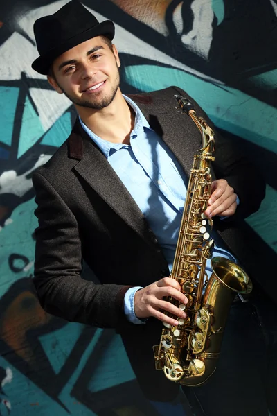 Young man with saxophone — Stock Photo, Image