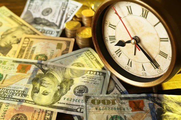 Money and alarm clock Stock Picture