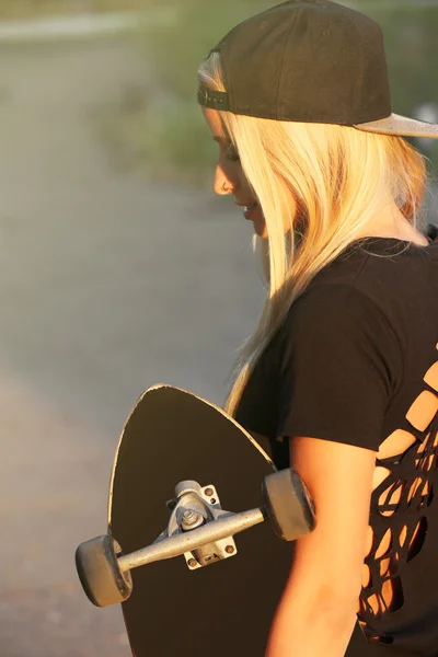 Young woman with skating board — Stock Photo, Image